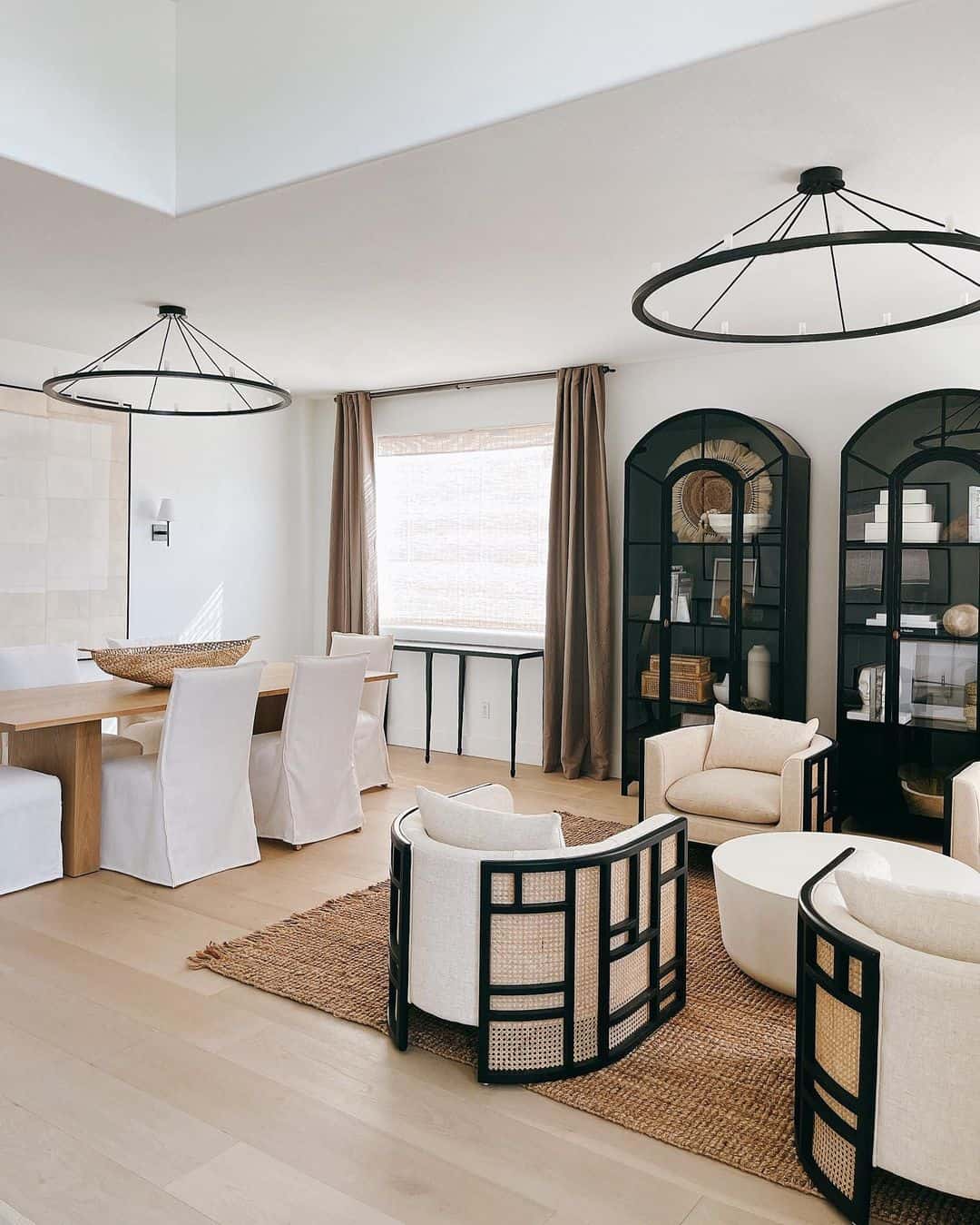 Arched Black Display Cabinets Frame a Cozy Seating Area
