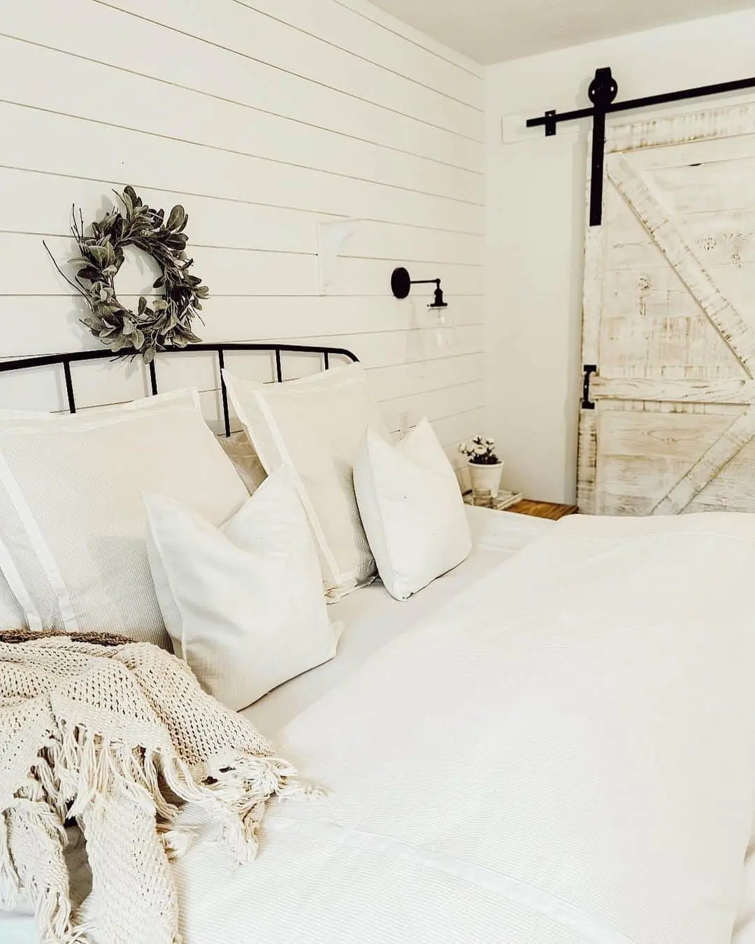 Sage Green Wreath Adds Organic Texture Above Bed