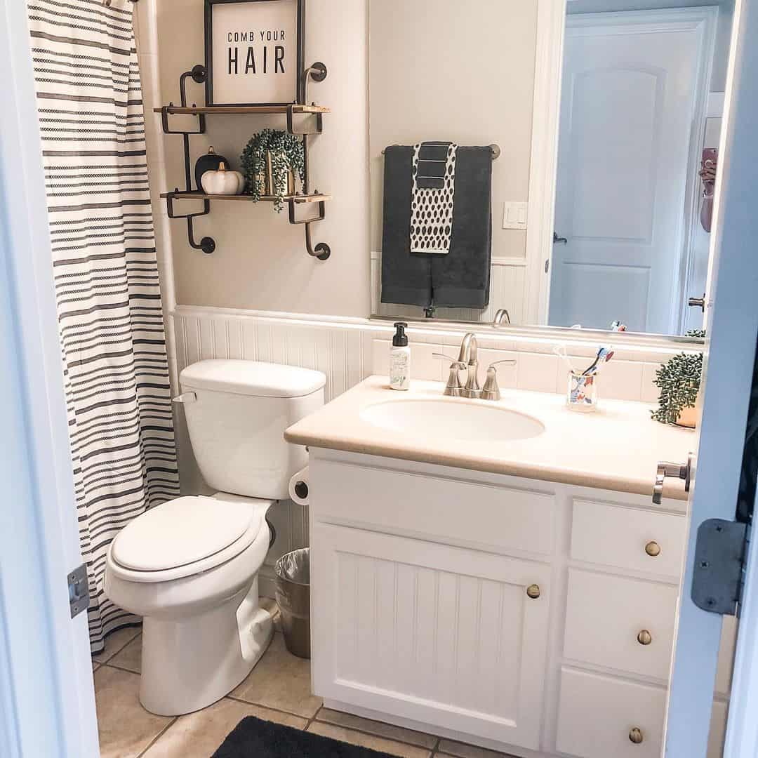 Industrial Pipe Shelving Holds Small Decor Accents Above Toilet