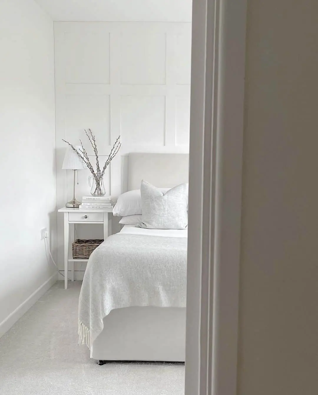 Paneled Walls Create a Soothing Grid in a Serene Bedroom