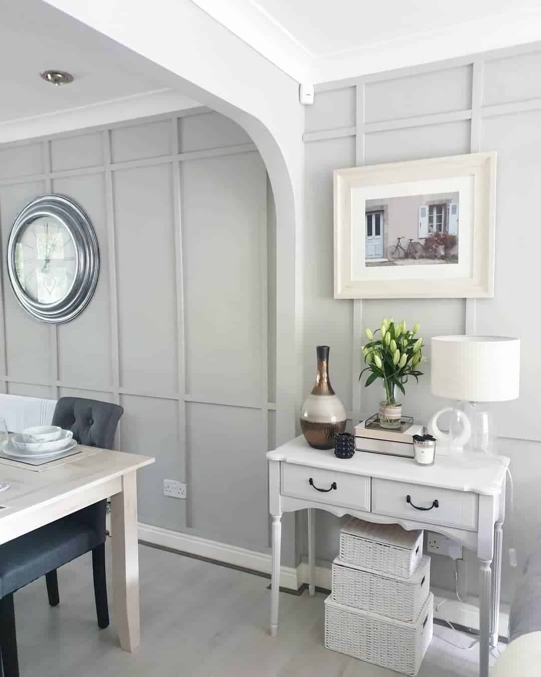 Framed Art and Vases Complement Geometric Wall Paneling