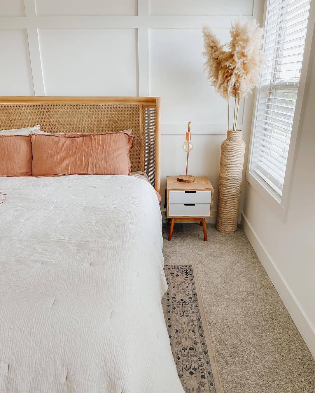 Cane Headboard with Terracotta Pillows for Warmth