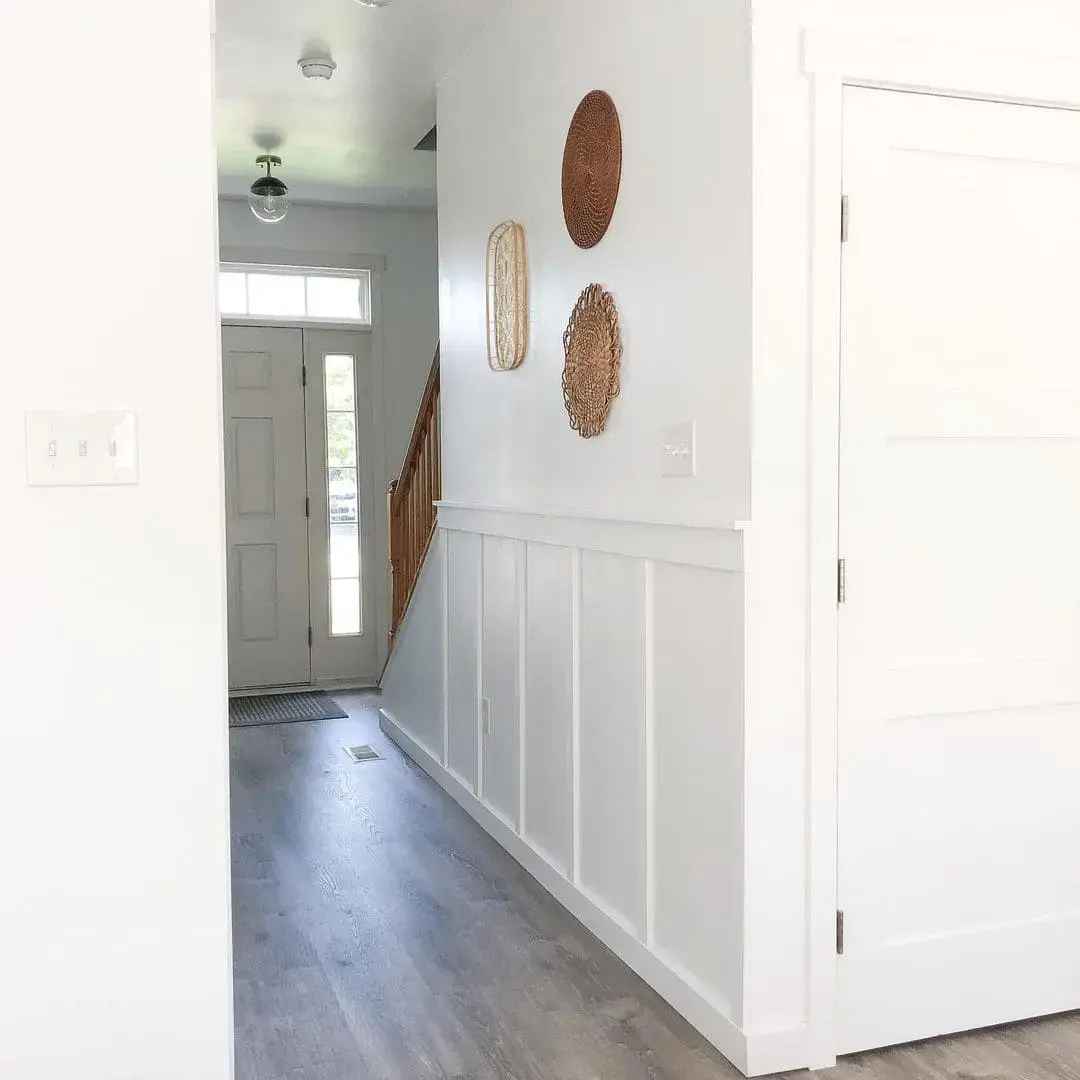 Woven Wall Hangings Add Organic Texture Above White Wainscoting