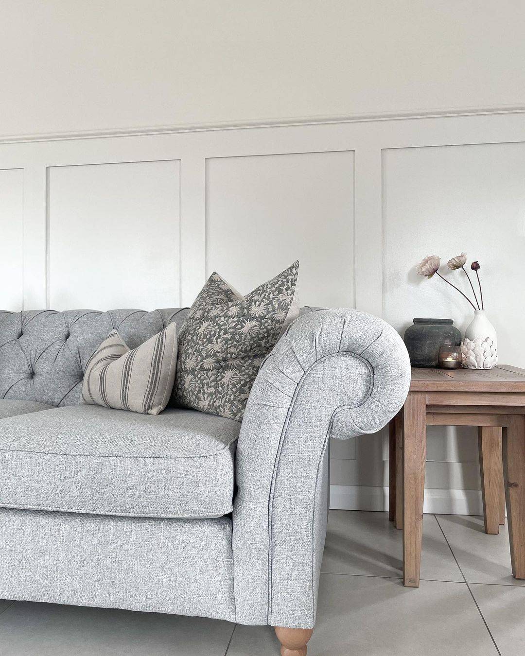 White Wainscoting Panels That Frame a Subtle Geometric Pillow
