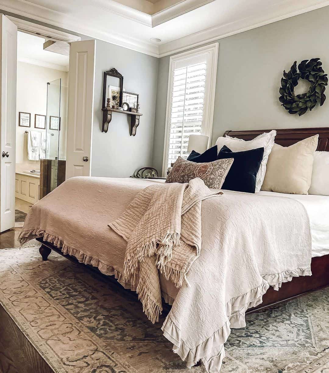 Dark Leafy Wreath Adds Natural Texture Above the Bed