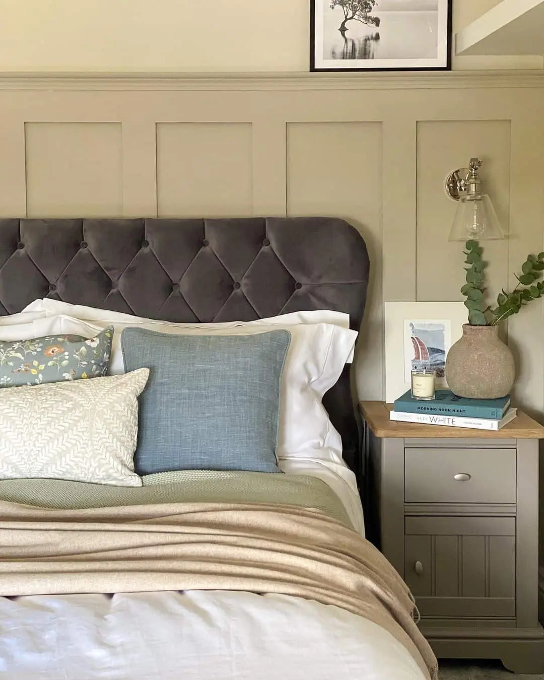 Neutral Paneling Accents Frame a Tufted Headboard