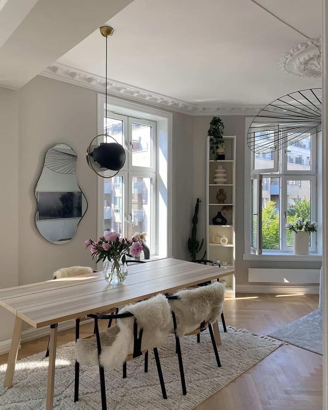 Amorphous Mirror Adds an Artistic Touch Above the Dining Table