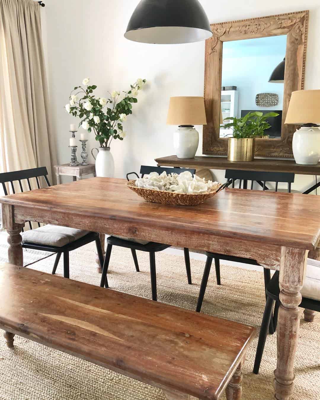 Carved Wood Mirror Frames a Warm, Inviting Dining Space