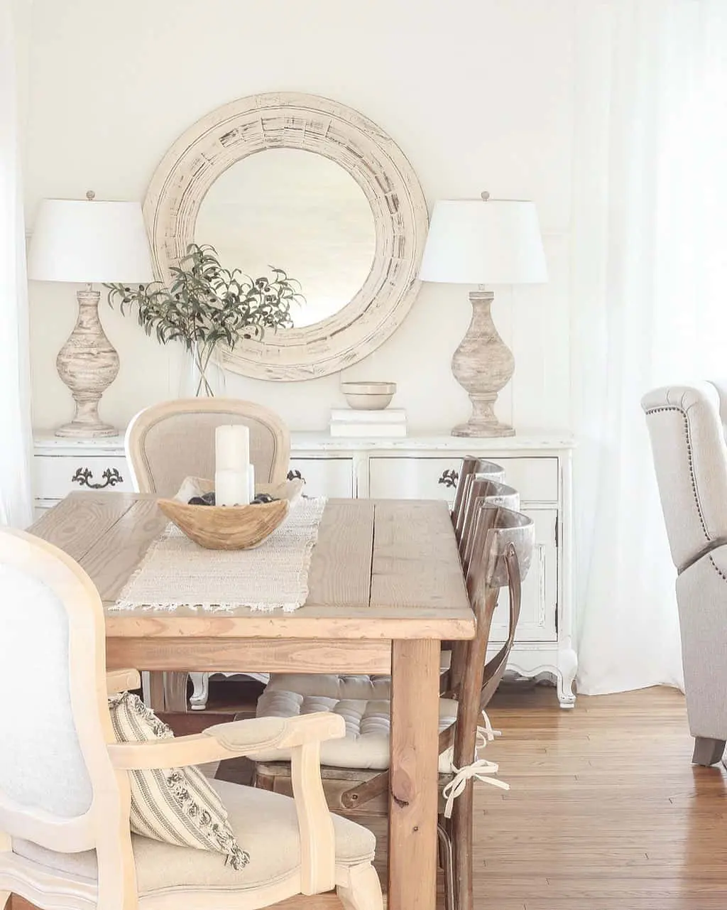 Round Mirror with Textured Frame Above Buffet