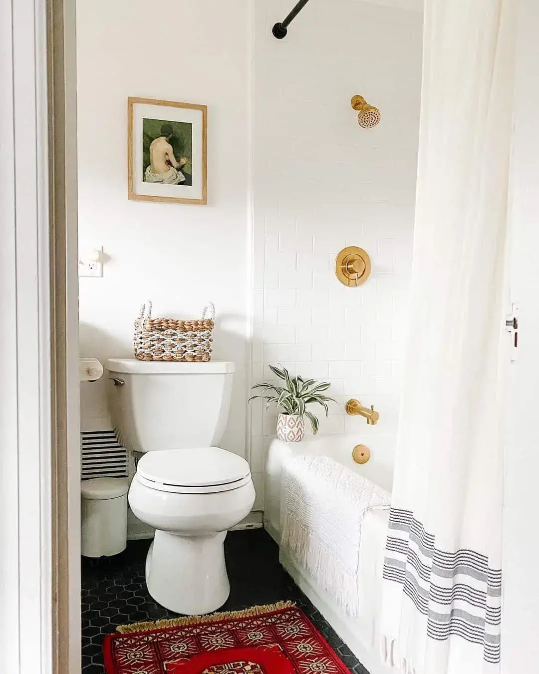 Gold Fixtures Sparkle Against White Subway Tile Shower Walls