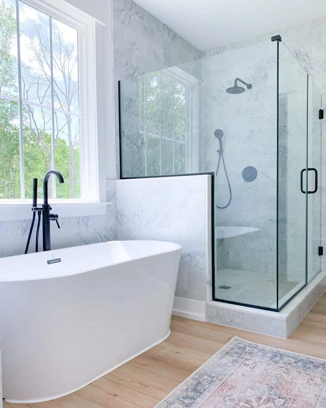 Frameless Glass Shower with Black Trim Defines the Space