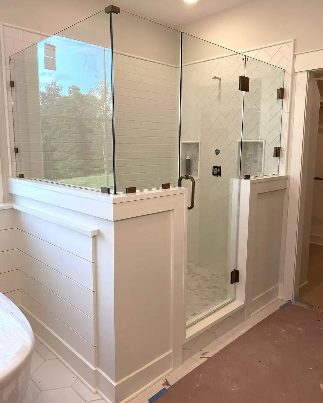 Glass Shower Enclosure with Dark Bronze Hardware for an Open Feel