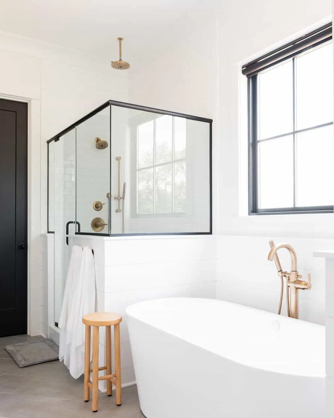 Brass Fixtures Add Warmth to a White Shower Stall