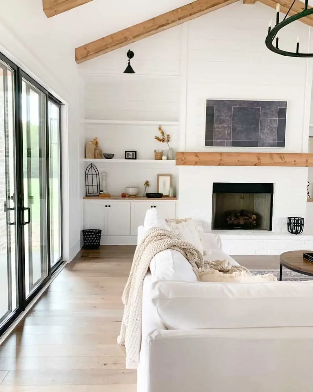 Frame Open Shelving with White Built-Ins Above a Fireplace