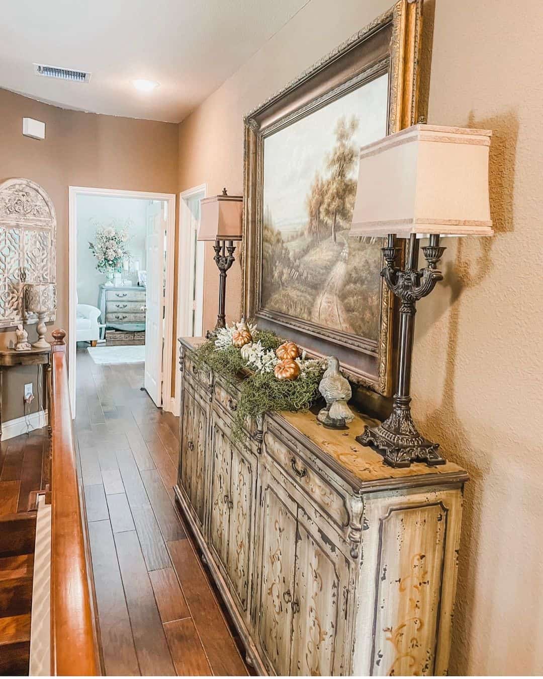 Distressed Cabinet Displays Autumnal Garland and Pumpkins