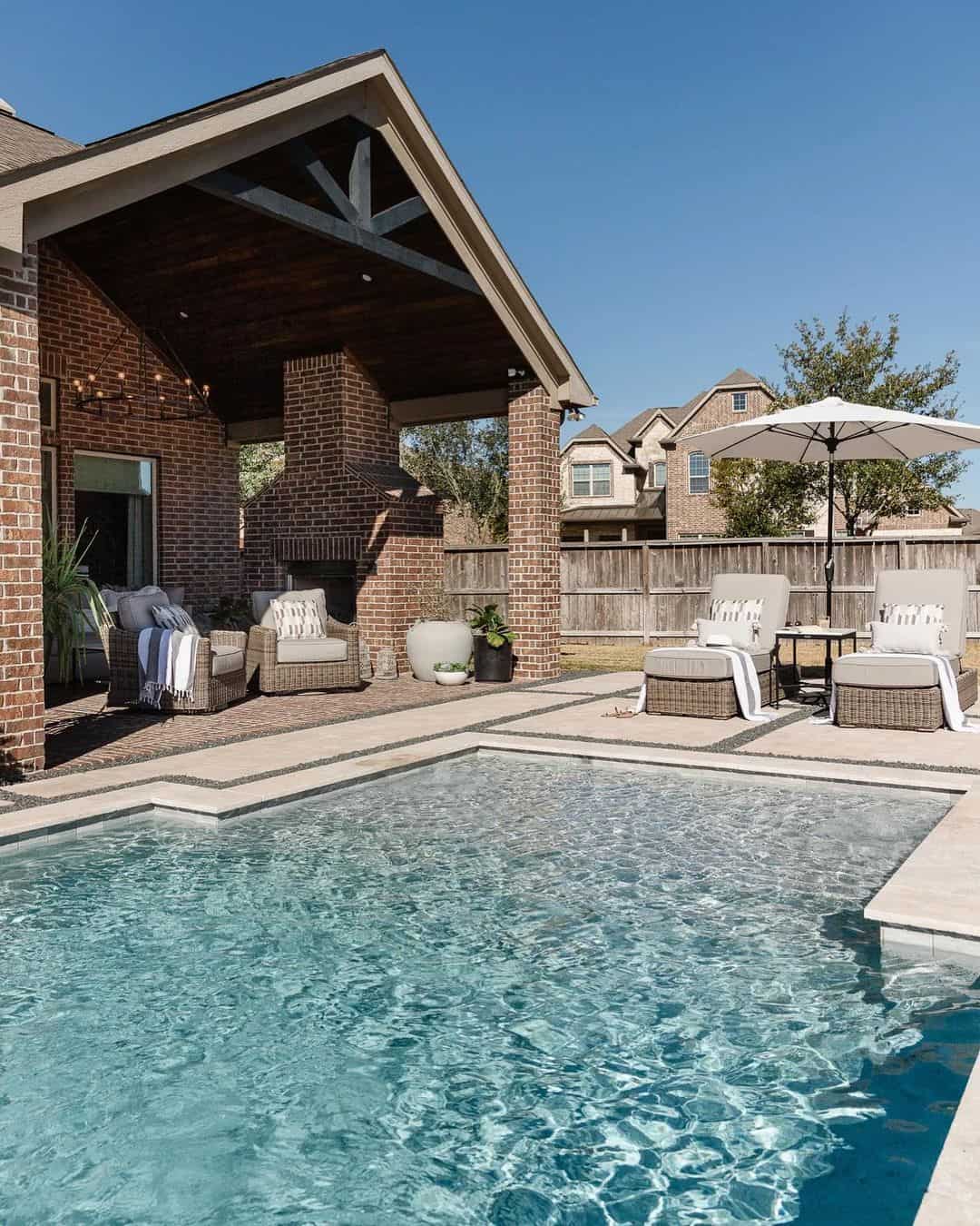 Covered Outdoor Fireplace Creates A Cozy Backyard Gathering Spot