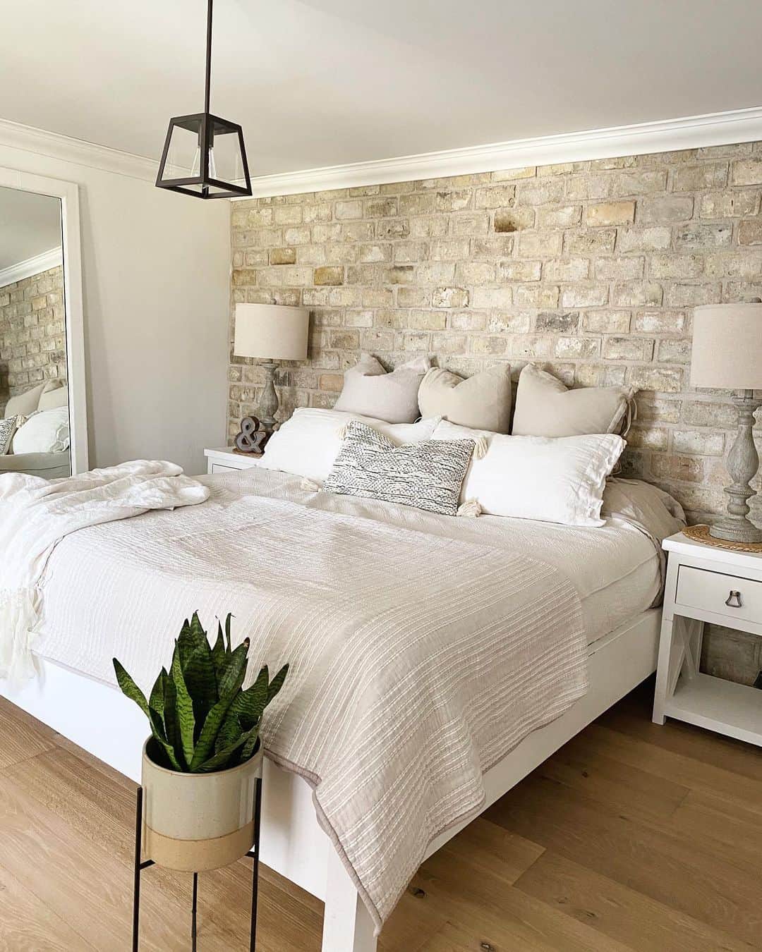 Floor mirror that leans against a brick wall