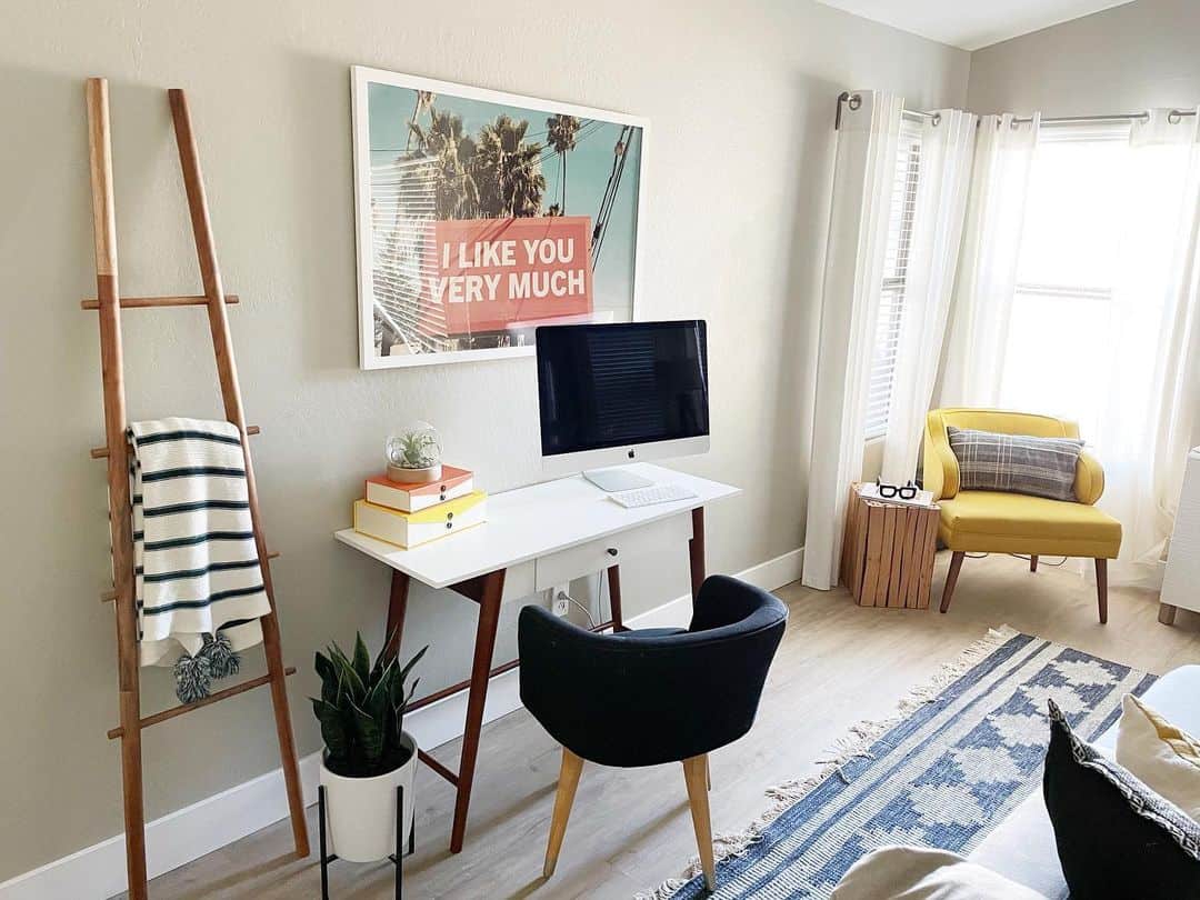 Wooden ladder displays blankets and plants for cozy texture