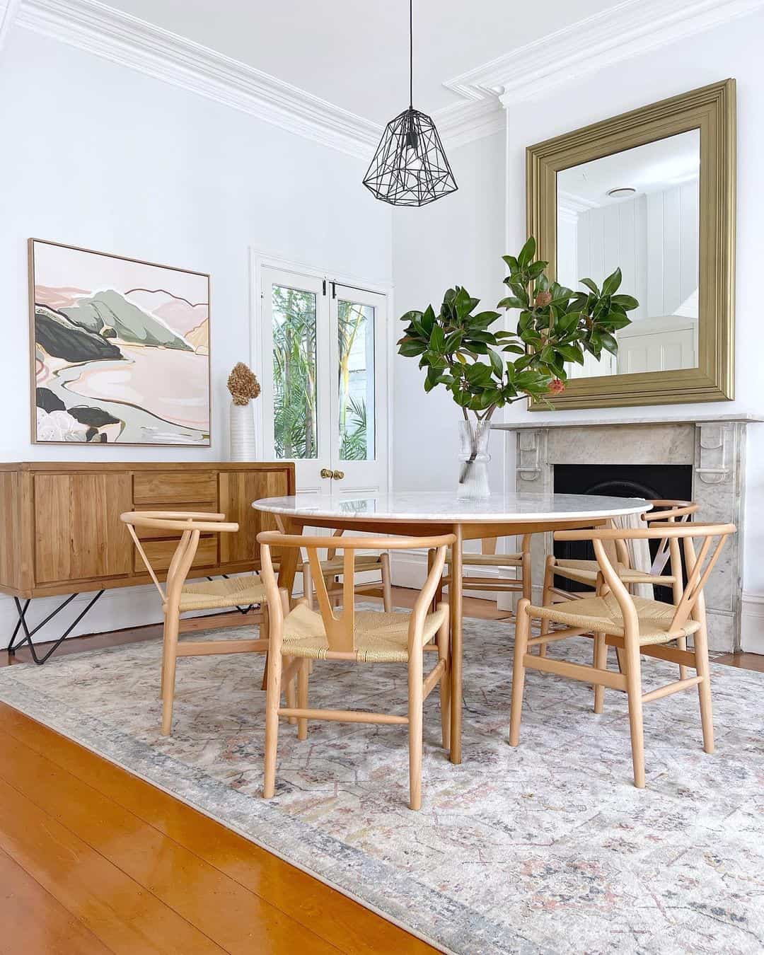 Round Marble Table with Wishbone Chairs Creates a Light Dining Area