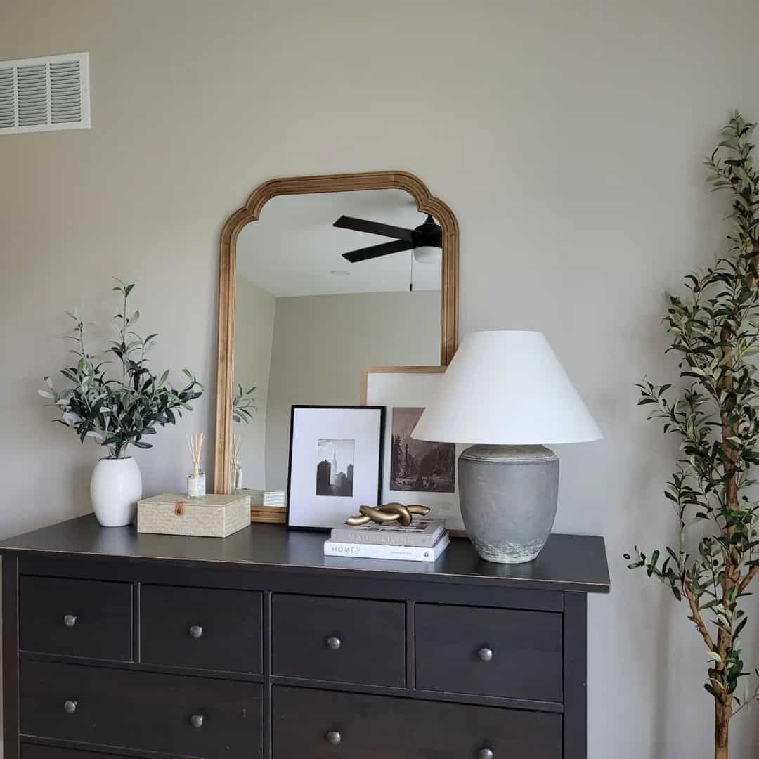 Curved Gold Mirror Adds Architectural Interest Above Dresser