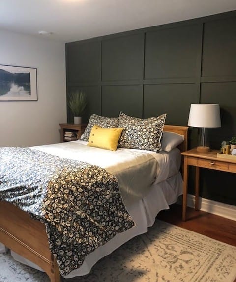 Deep Green Paneling Creates a Dramatic Bedroom Accent Wall