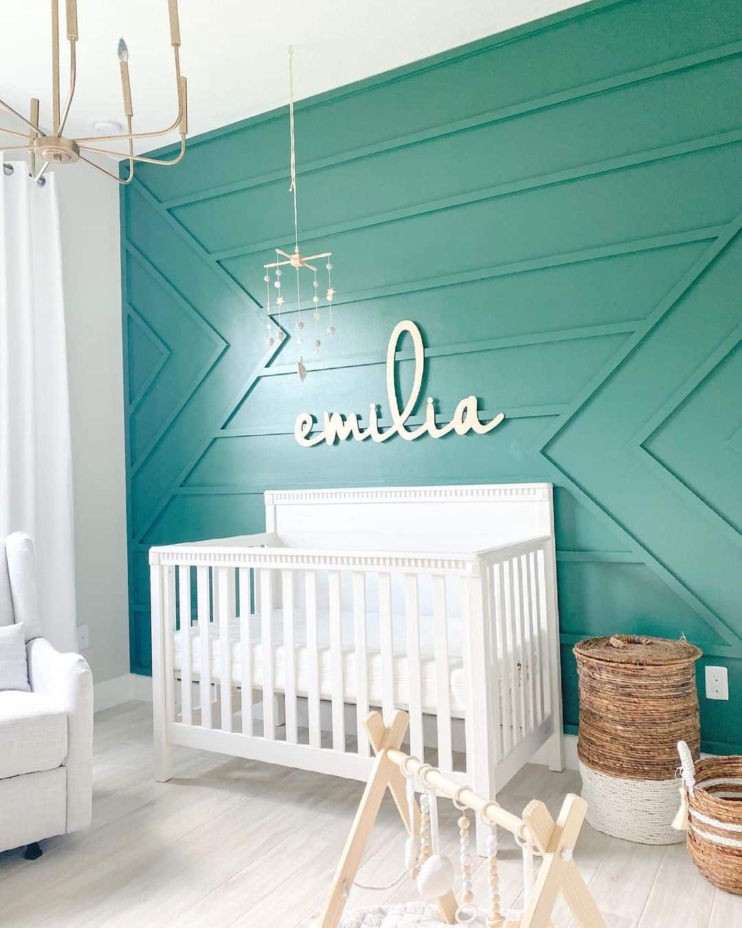 Geometric Green Board and Batten Walls Frame a Nursery
