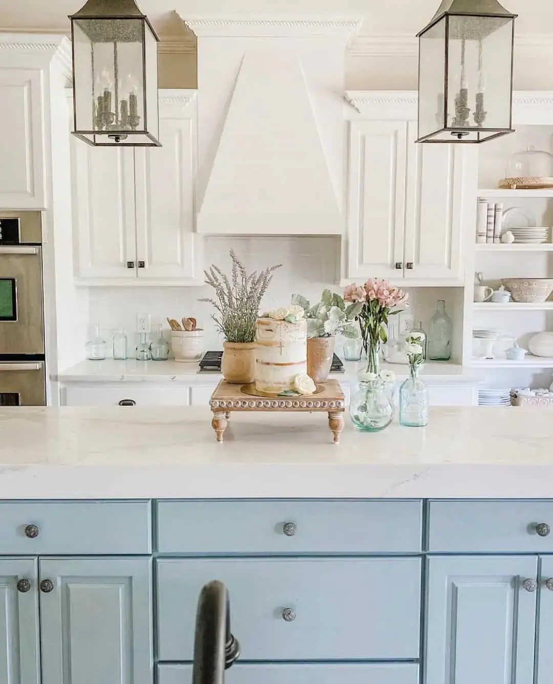 Pale Blue Island Cabinets With Ornate Crystal Knobs