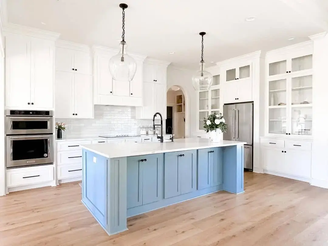 Pale Blue Island Cabinets Add a Pop of Color to White Kitchen