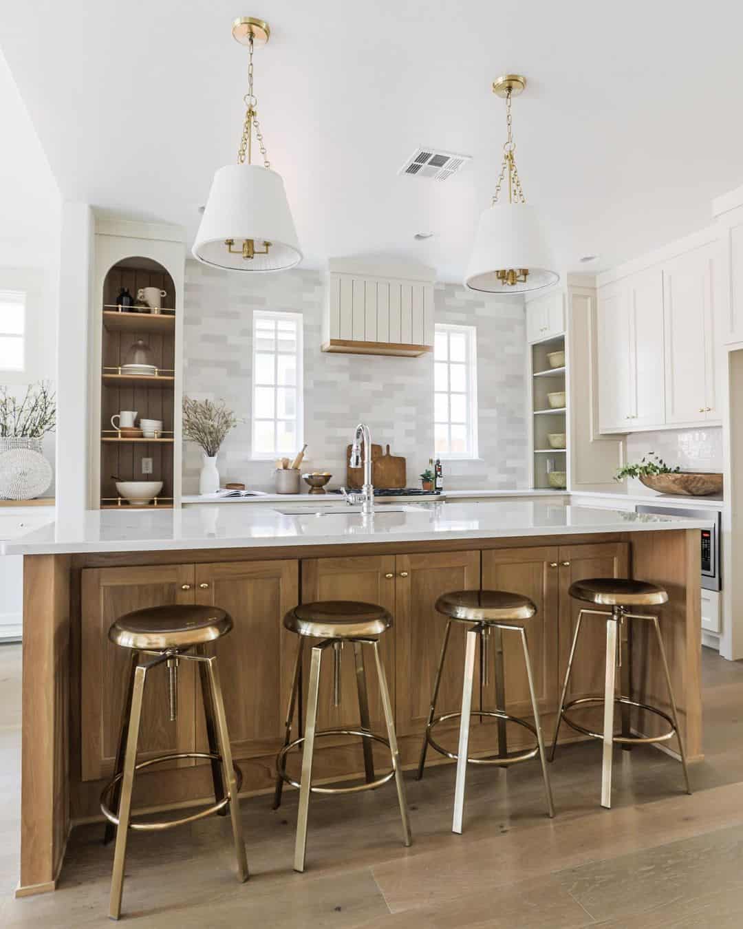 Warm Wood Island Base Pairs With Brass Bar Stools