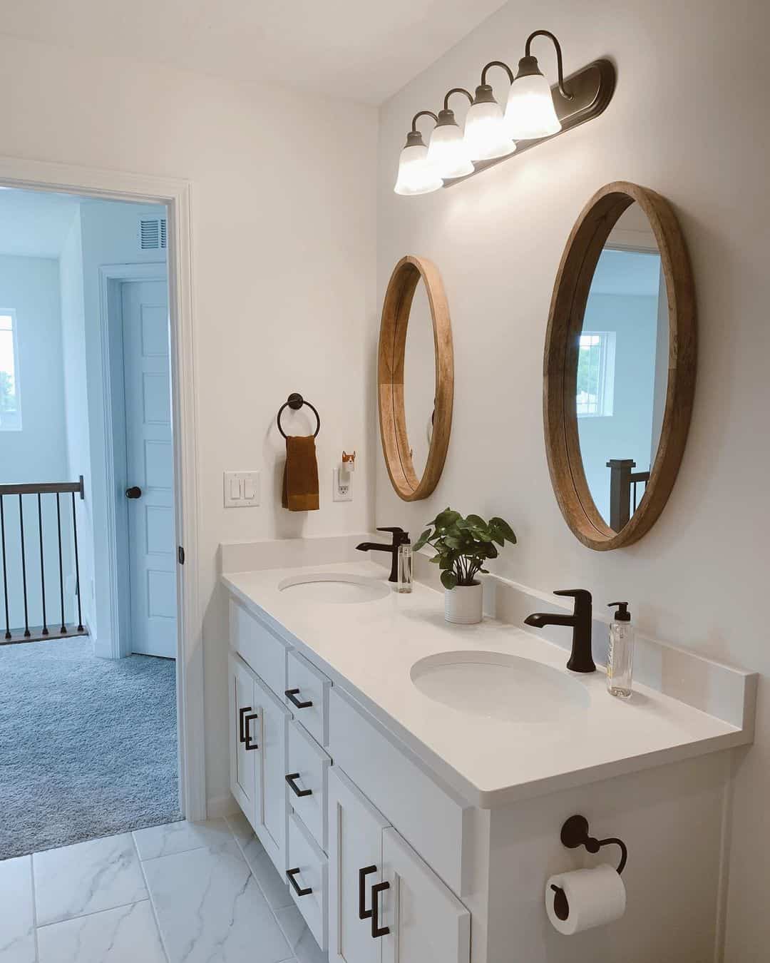 Oval Wood Mirrors Add Natural Warmth Above White Vanity