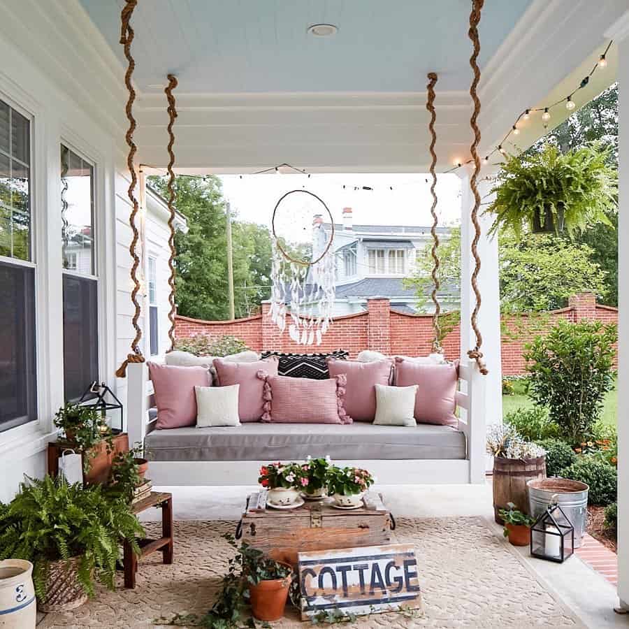 Dusty Rose Pillows Add Softness to White Porch Swing