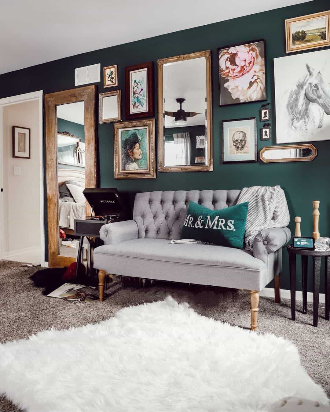 Gallery Wall of Mirrors and Art Adds Depth to Green Walls