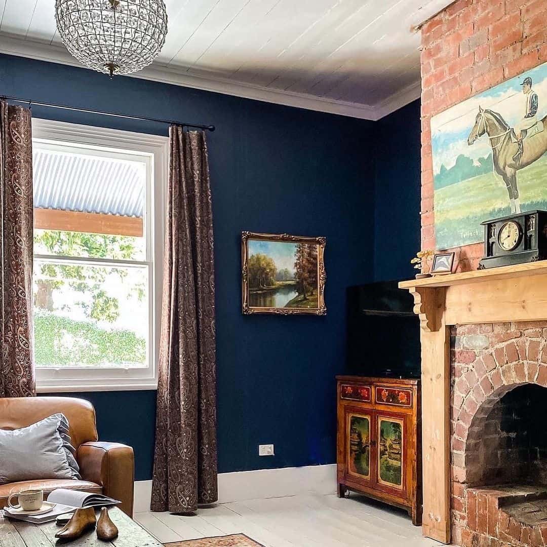 Deep Navy Walls Frame a Cozy Reading Nook