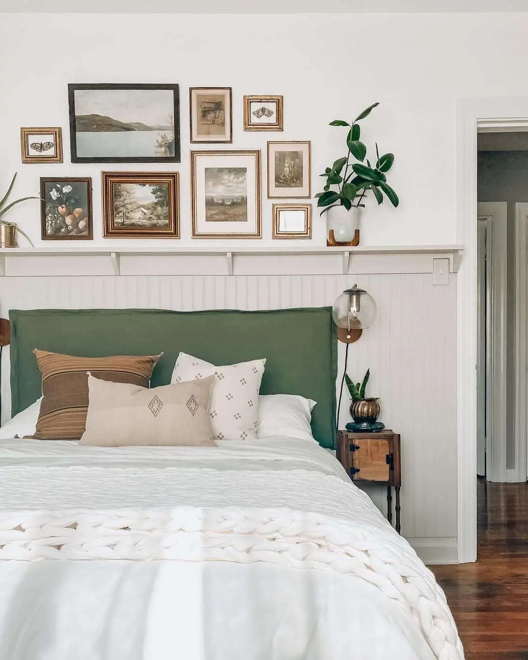 Layer Small Framed Art Above a Headboard