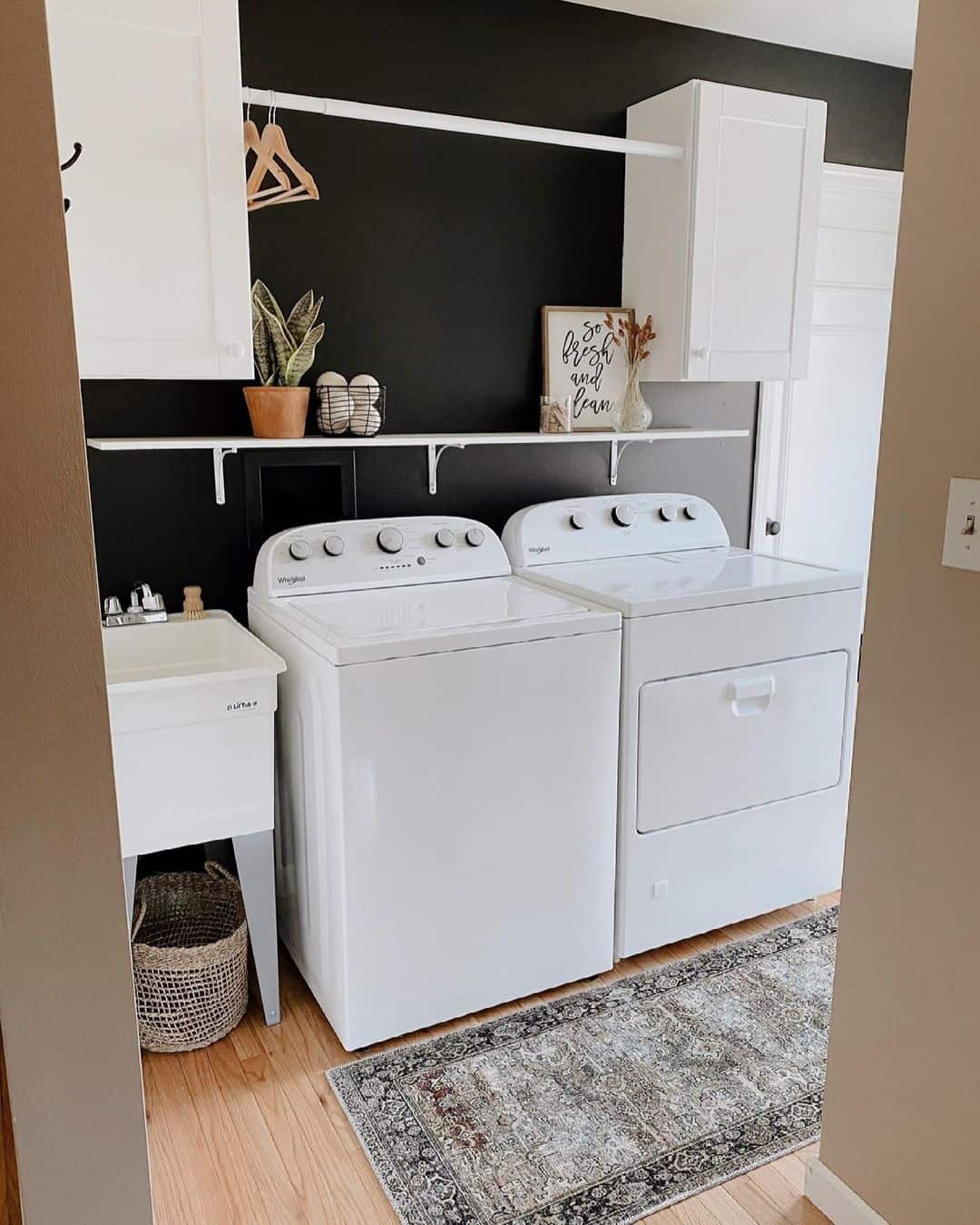 Black Accent Wall Creates a Dramatic Backdrop for Laundry