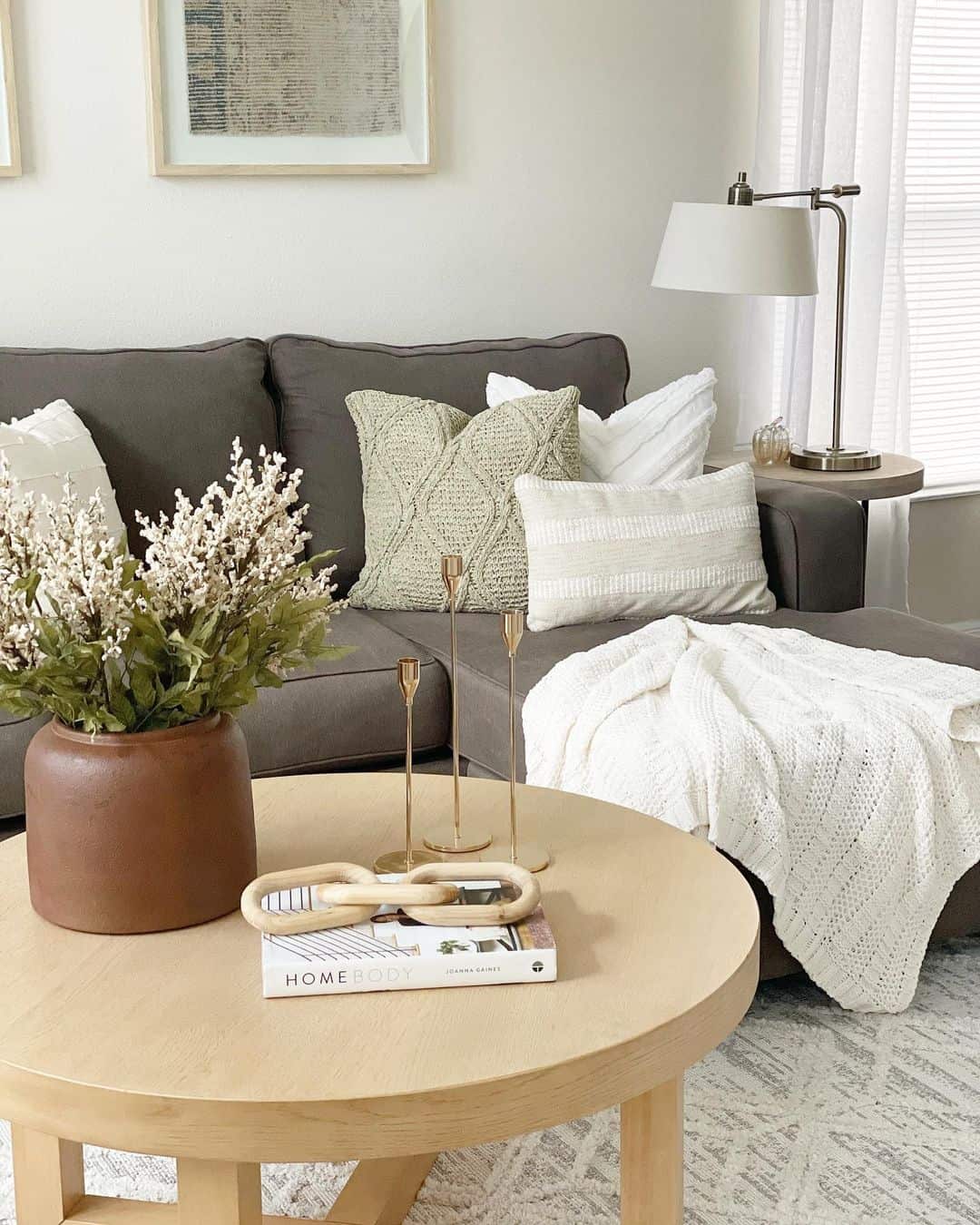 Tall Brass Candlesticks Add Delicate Verticality To Your Sofa Display