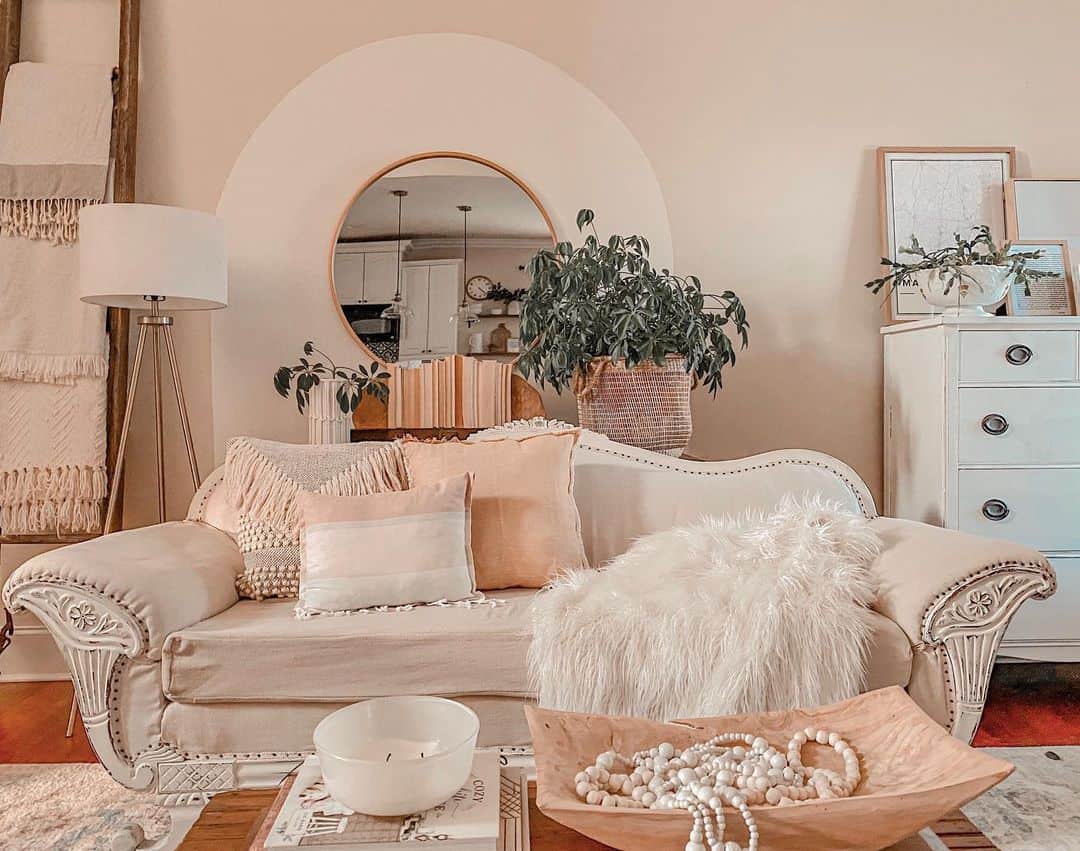Round Mirror Adds an Archway Effect Above the Sofa