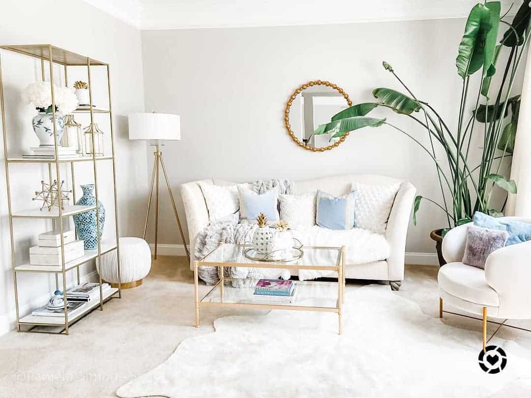 Gold-Framed Shelving Unit Displays Blue and White Decor