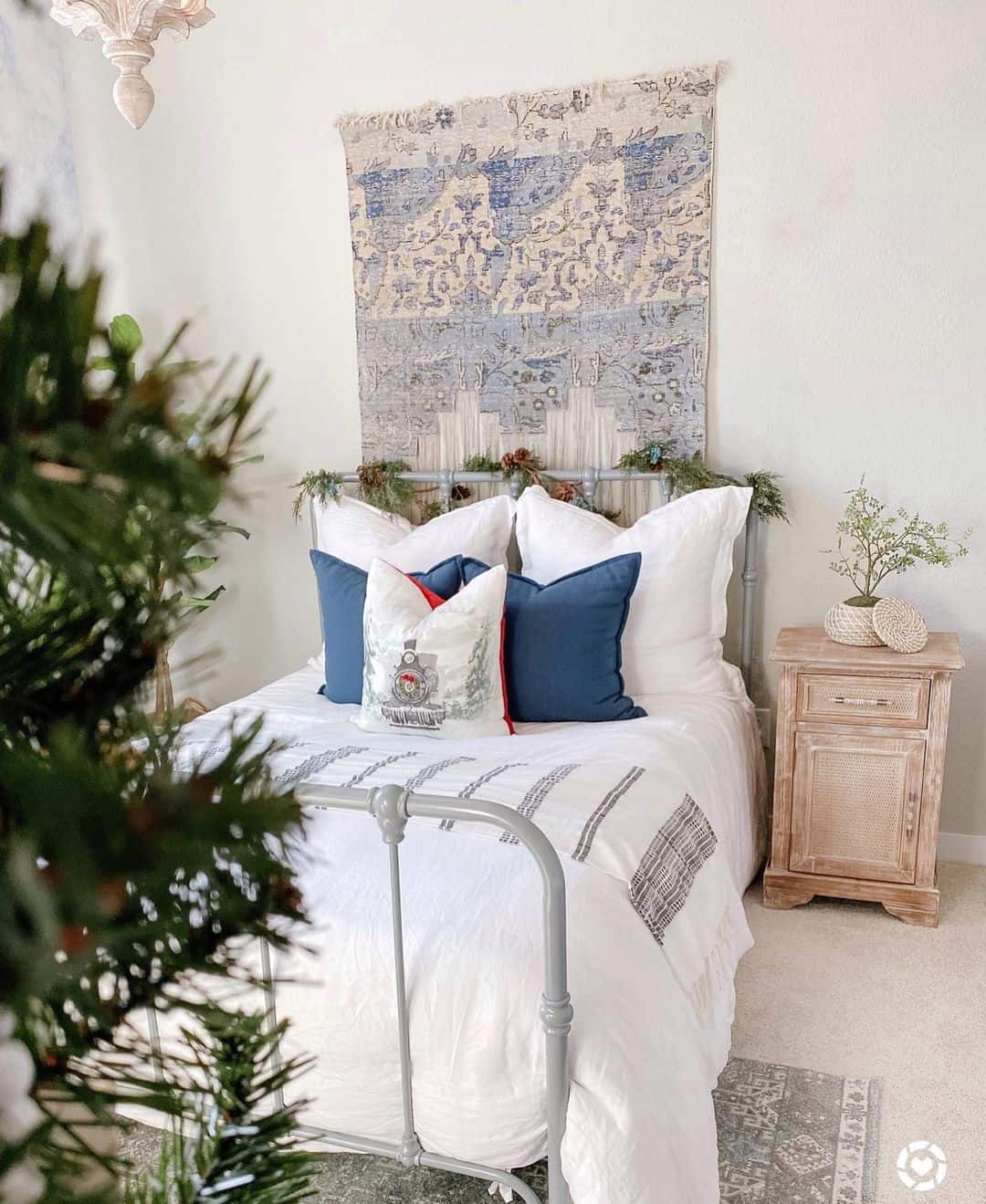 Textile Wall Hanging Adds Pattern Above a Metal Bed Frame