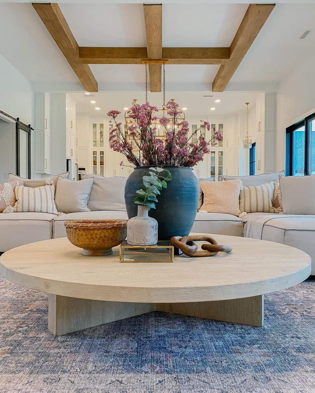 Oversized Round Table Anchors Living Space With Natural Textures