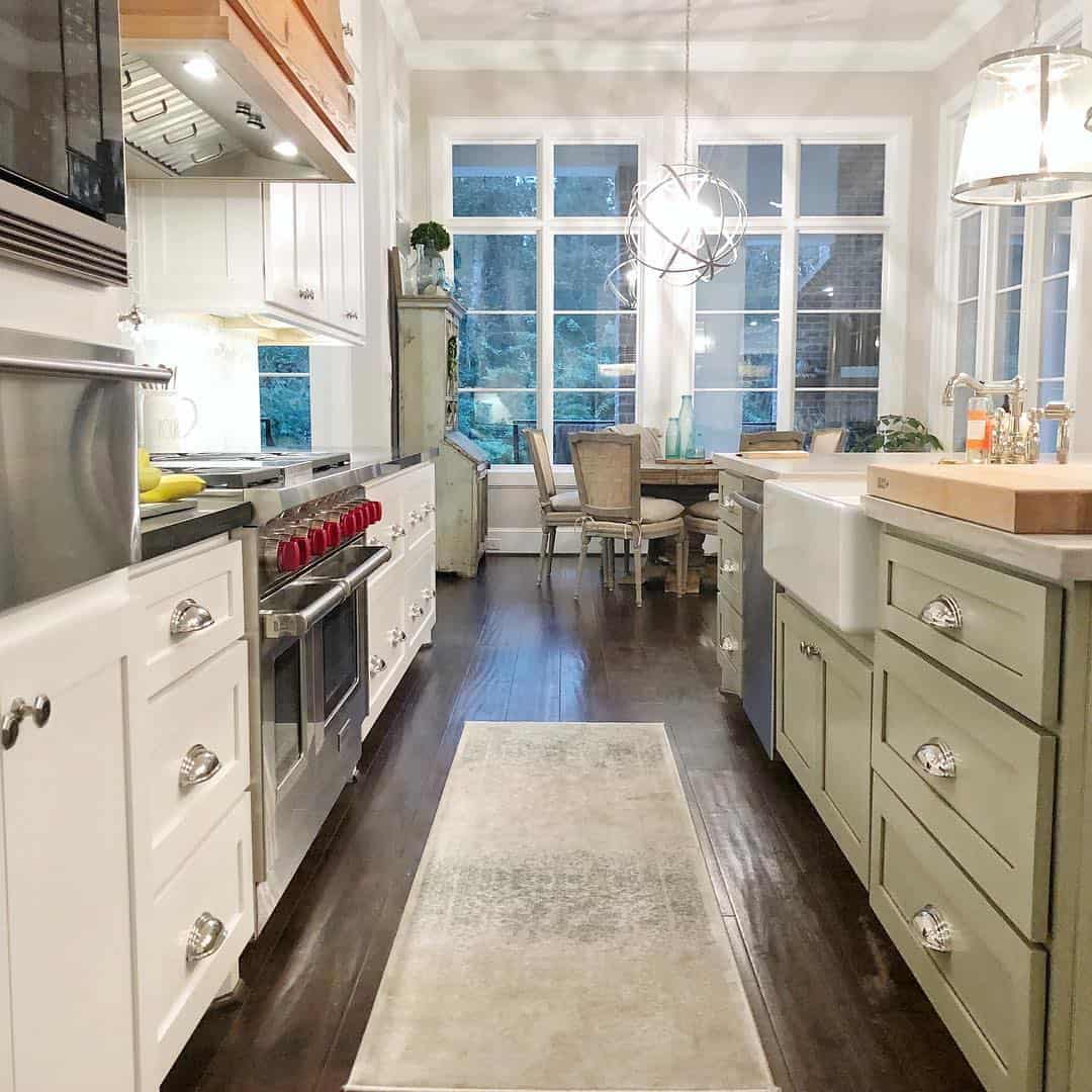 Adorn sage green drawers with ornate cup pulls and a farmhouse sink
