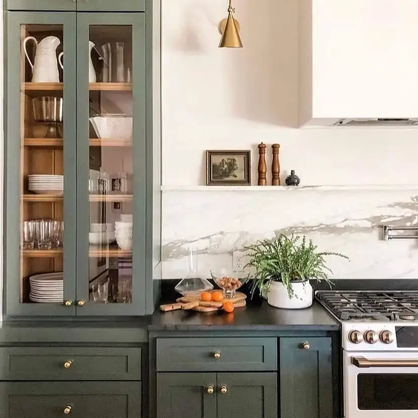 Showcase dishware in glass-fronted sage green cabinets