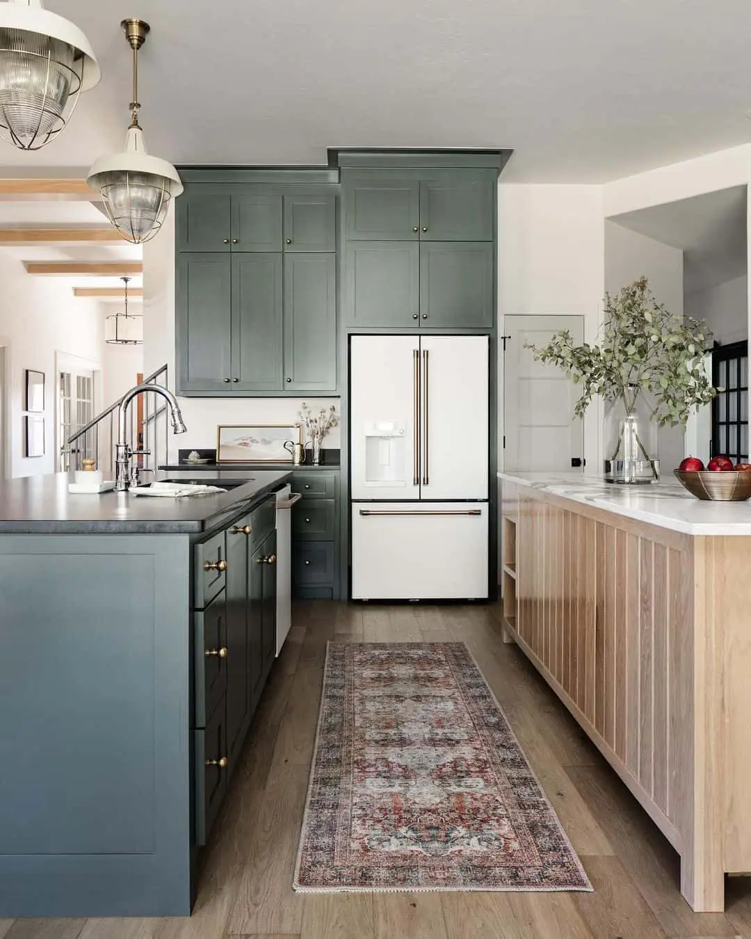 Warm up sage green cabinets with brass hardware