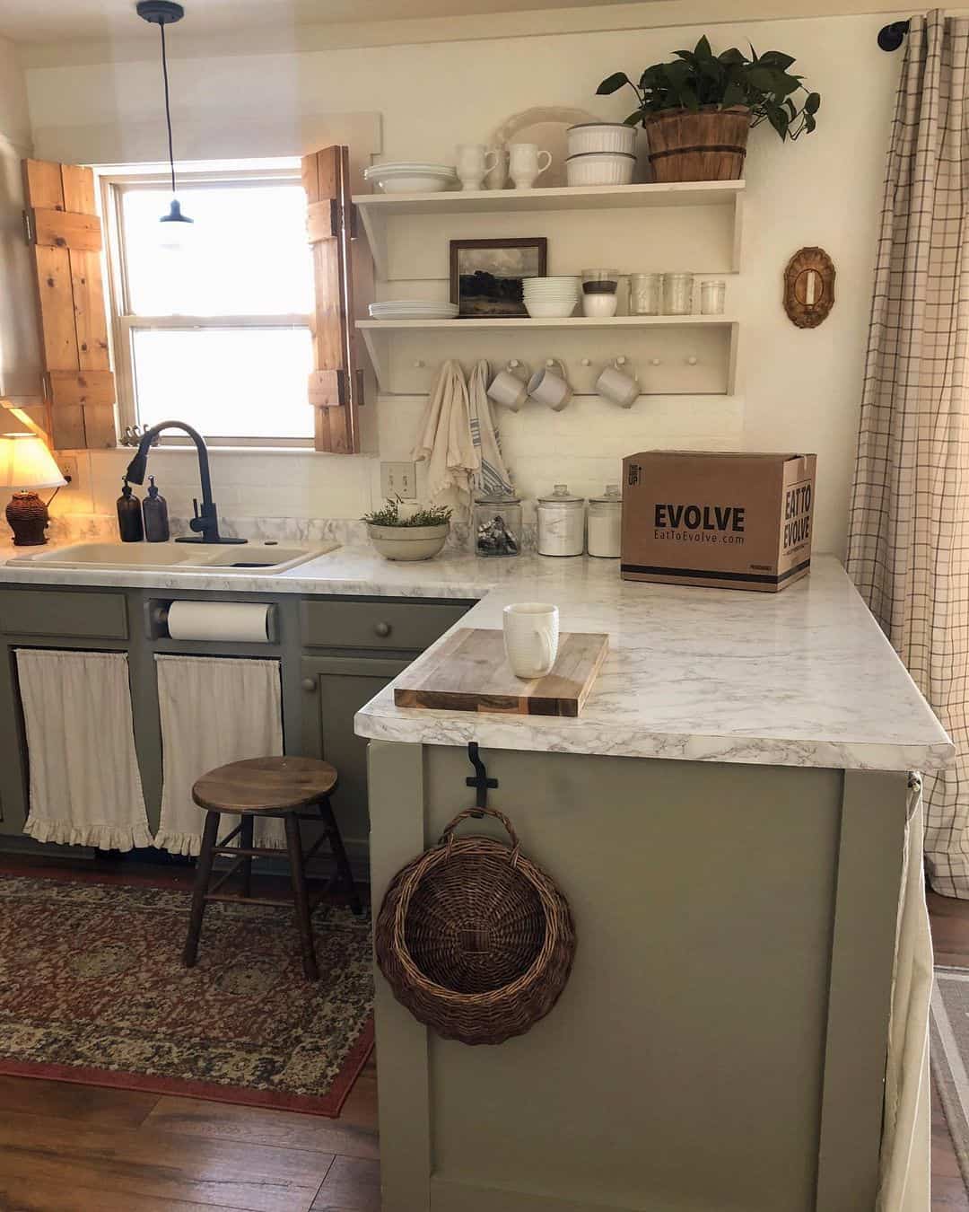 Sage green cabinets with a woven basket hanging hook