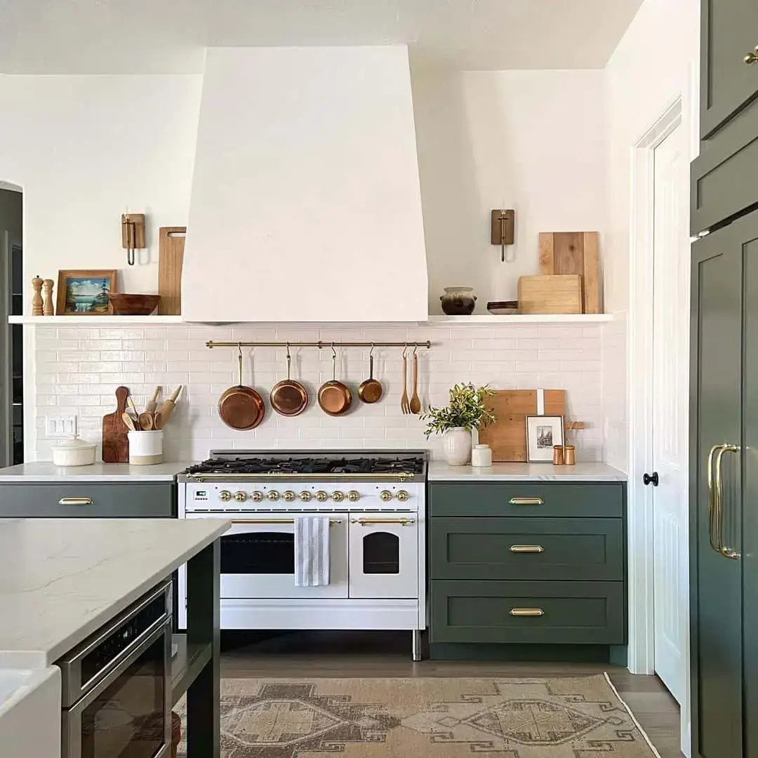 Brass pot rack with copper cookware adds warmth