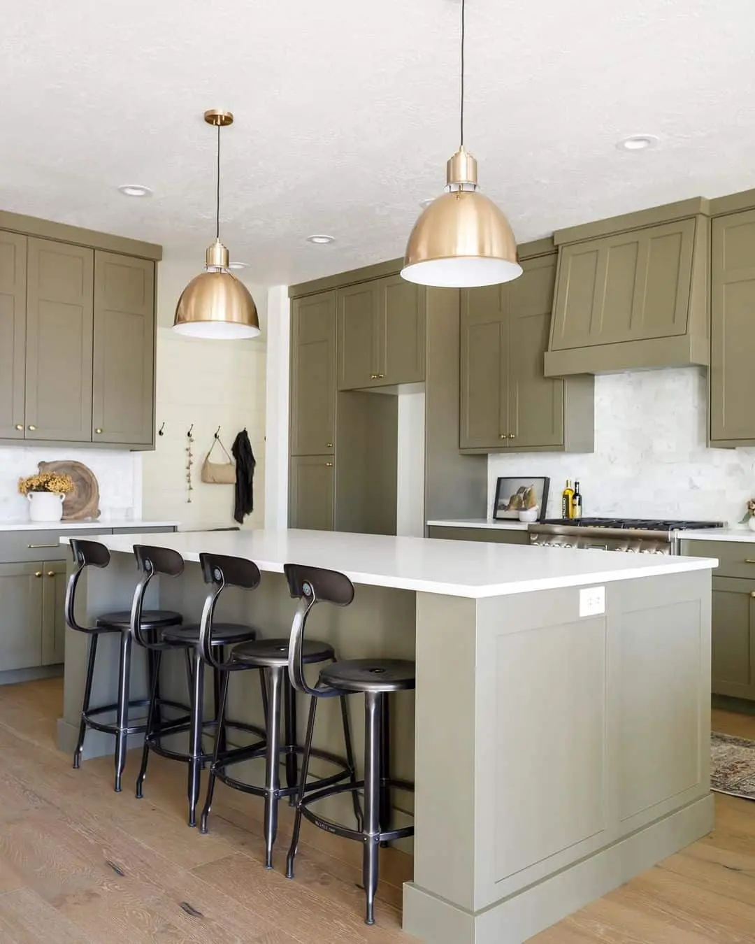 Pair sage green island with industrial black stools
