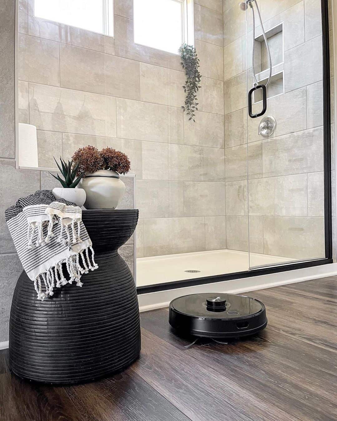 Black Sculptural Side Table Holds Towels and Decor
