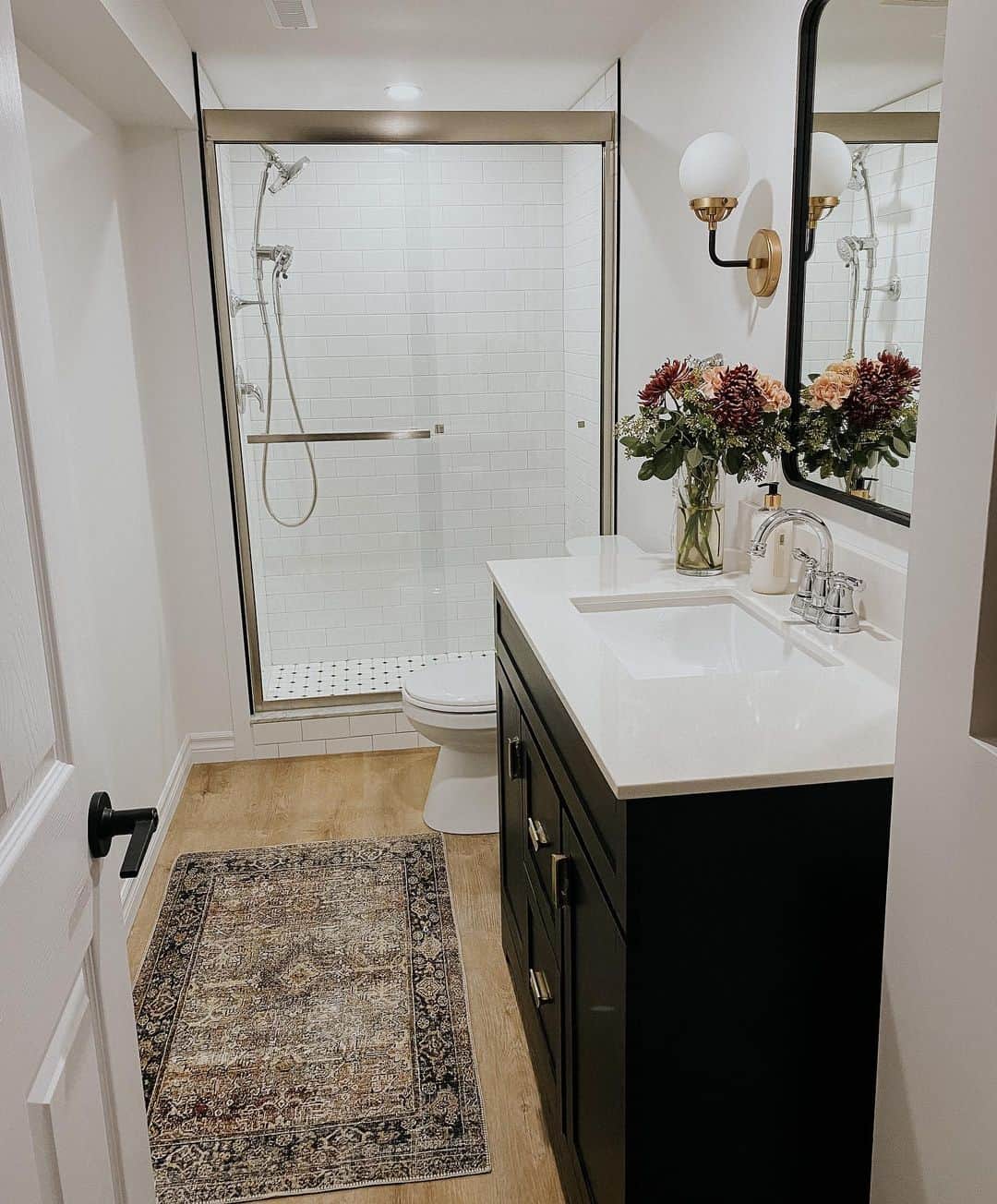 Black Vanity With Brass Hardware Adds Dramatic Contrast