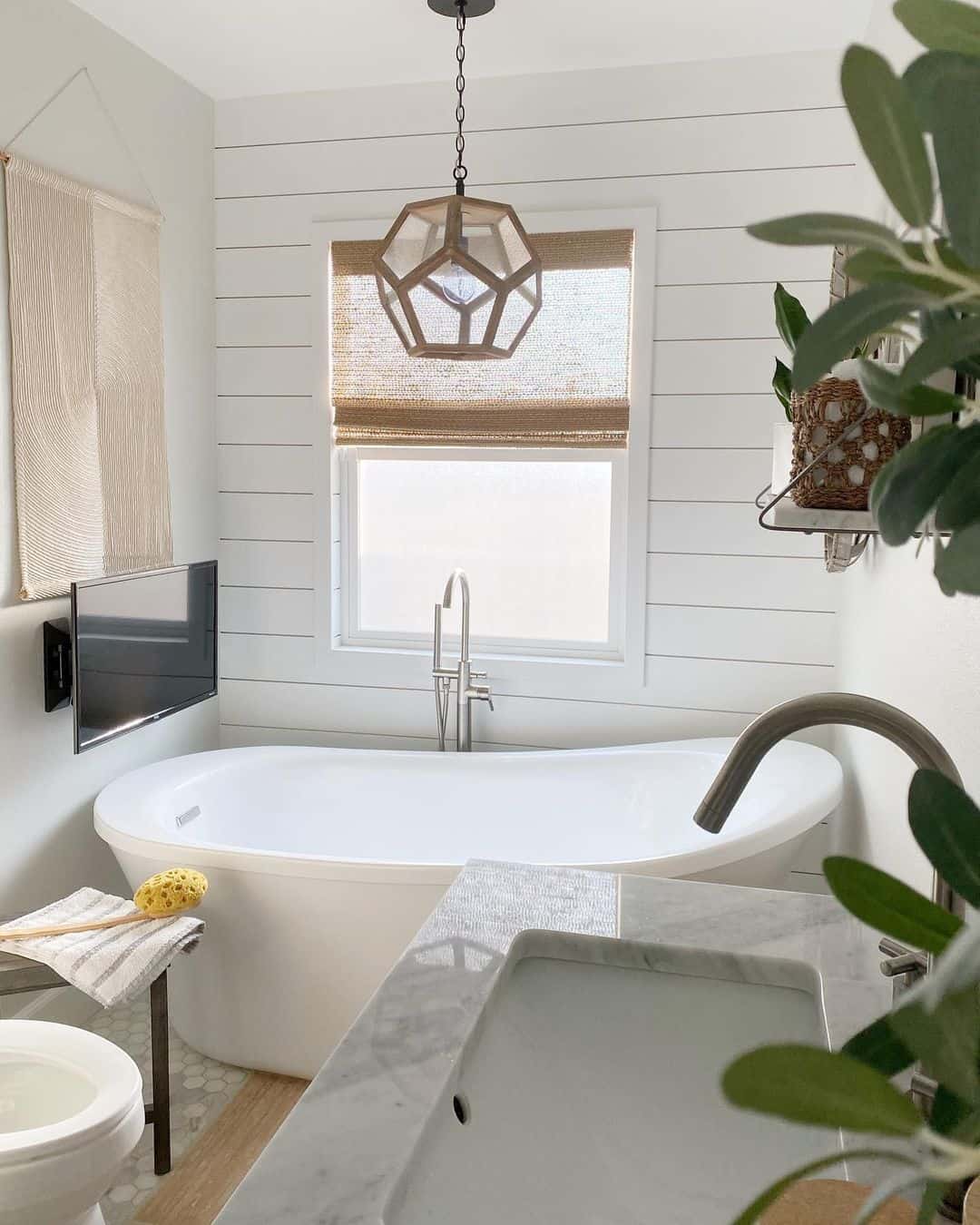Geometric Pendant Light Adds Sculptural Interest Above Tub