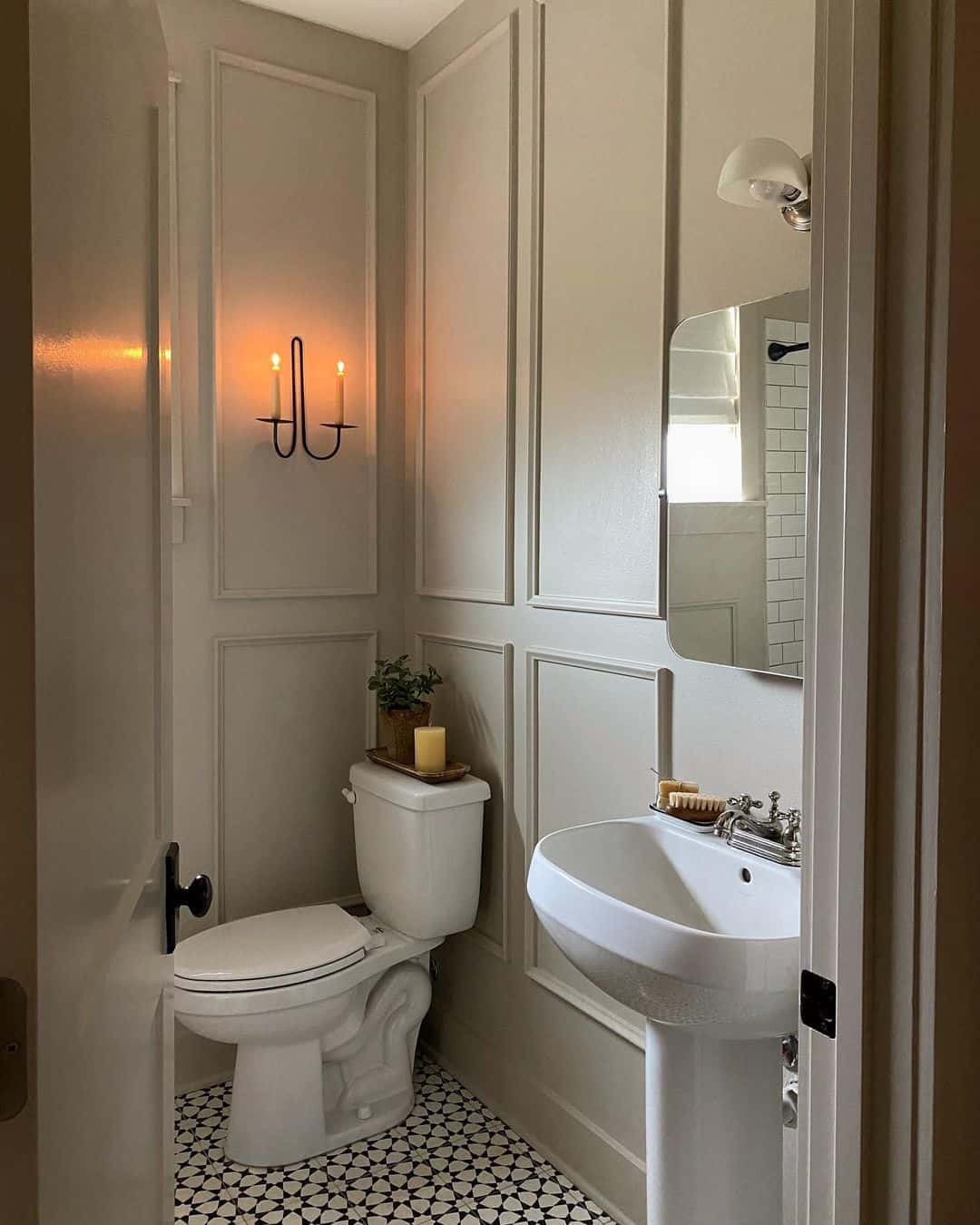 Candle Sconce Adds Warm Ambiance to Paneled Walls